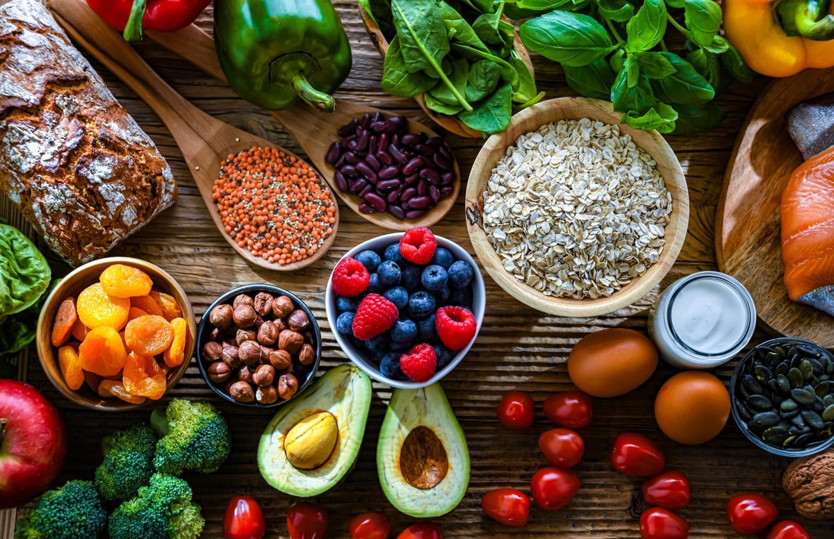 High resolution display of healthy nutritious food, colorful vegetables, fruits, nuts and grains on dark background